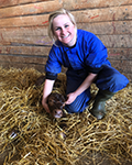 photo of Eline Nijhof in barn with animal